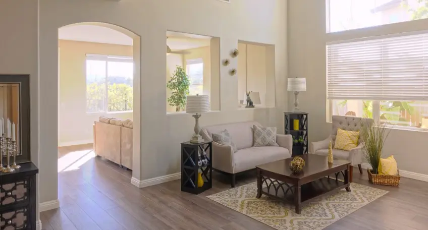 A staged living room with neutral colours and minimal clutter