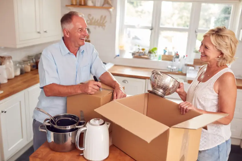 Senior couple packing to begin downsizing