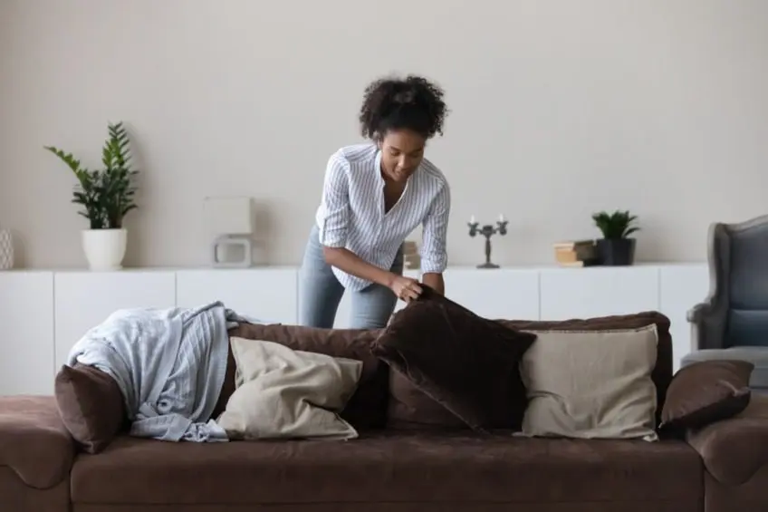 Woman staging living room of house