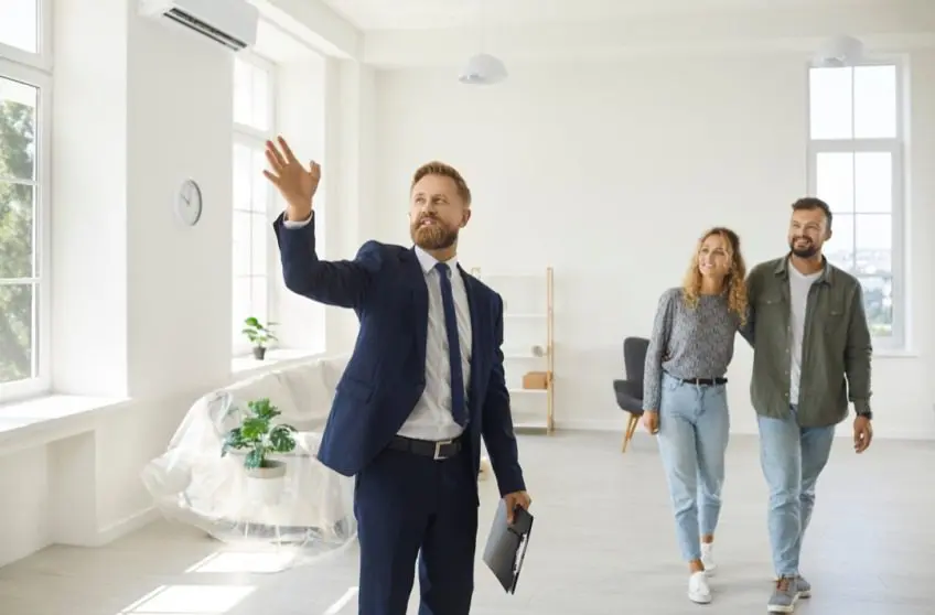 Real estate agent showing home to couple