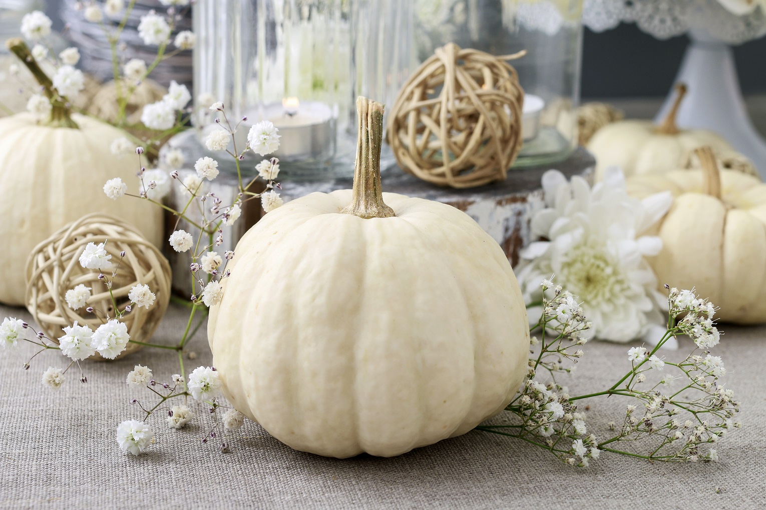 seasonal decorating ideas floral decoration with white pumpkins called baby boo and chrysanthemum flowers.