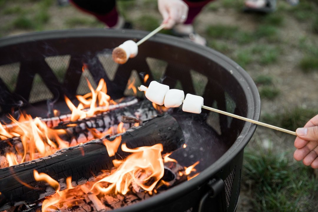 Roasting marshmallows in outdoor fire pit