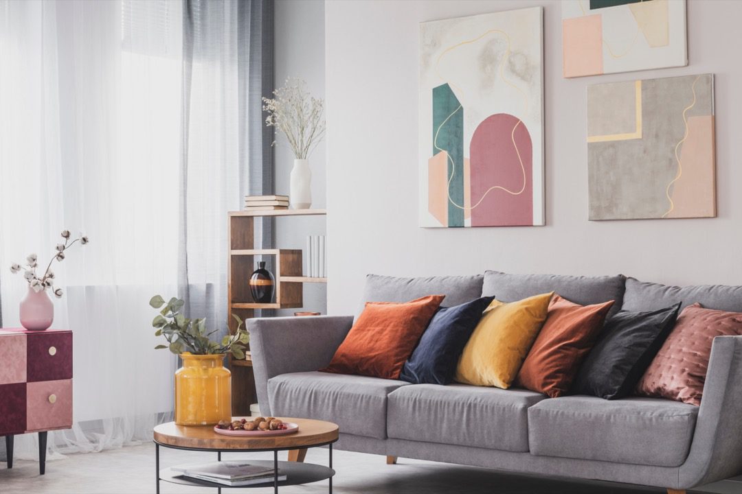 Bright throw cushions on couch in living room
