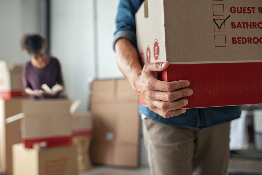 Couple packing moving boxes to move house