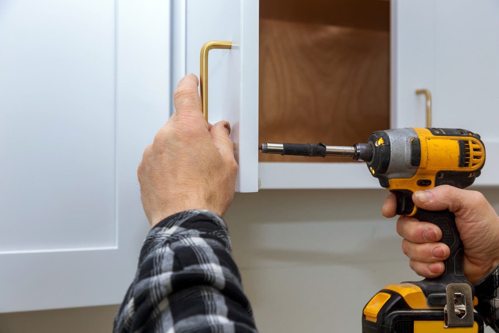 Man installing kitchen hardware